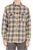Plaid shirt with yellow and gray pattern worn by a person on a white background