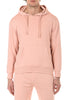 Person wearing a pink hoodie and pants on a white background