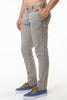 Person wearing green pants and blue sneakers on a white background