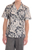 Person wearing a floral patterned shirt on a white background