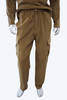person wearing copper colored velour cargo jogger against white background