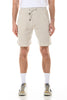 Beige shorts worn by a person on a white background