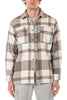 Man wearing a plaid shirt with brown and white pattern on a white background