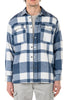 Person wearing a blue and white plaid shirt with a button-up front.