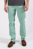 Person wearing light green pants and brown shoes on a white background