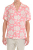 Person wearing a pink floral short-sleeve shirt on a white background