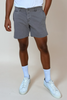 model wearing grey shorts on tan background