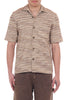 Man wearing a patterned beige shirt with short sleeves on a white background
