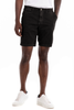 Person wearing black shorts and white sneakers on a white background
